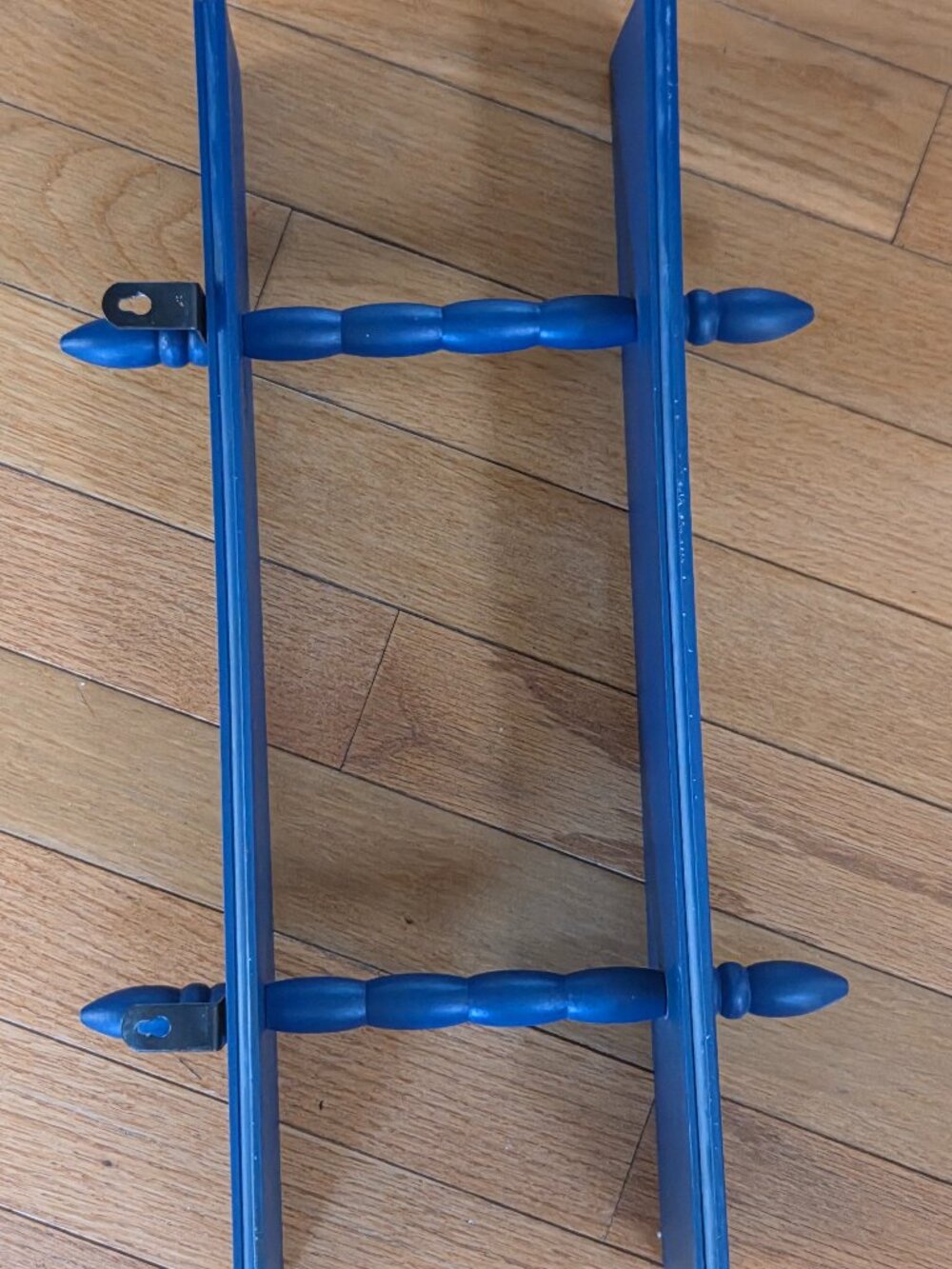 small blue two-tiered shelf approx. 16 inches long